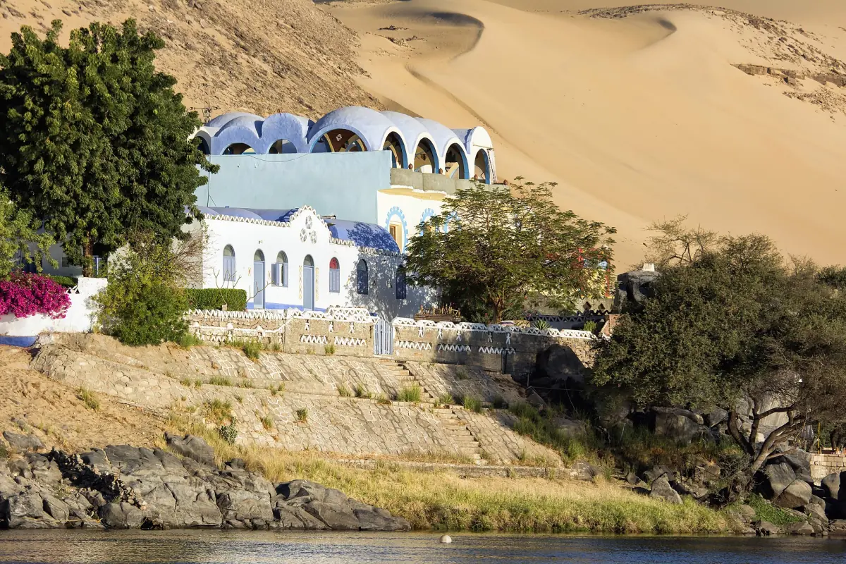 Colorful Nubian houses below desert dunes