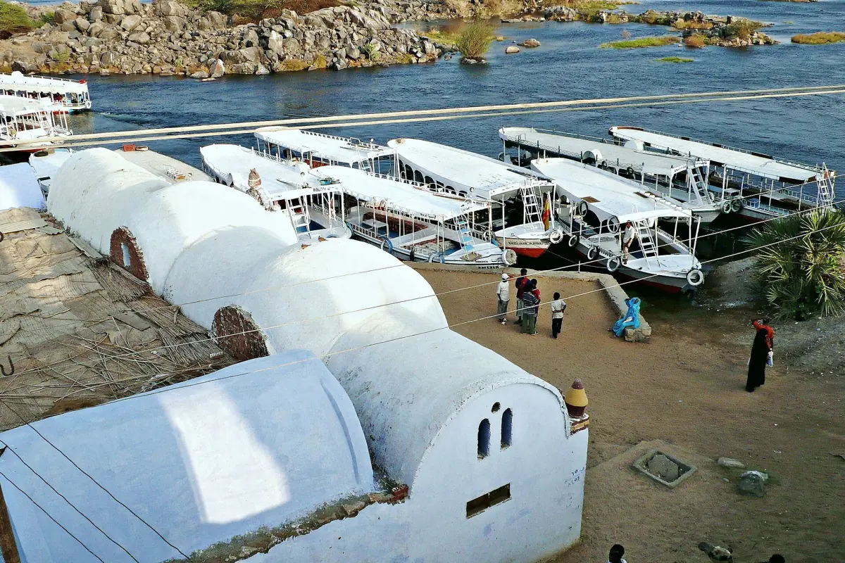 White domed Nubian houses above boats on the Nile